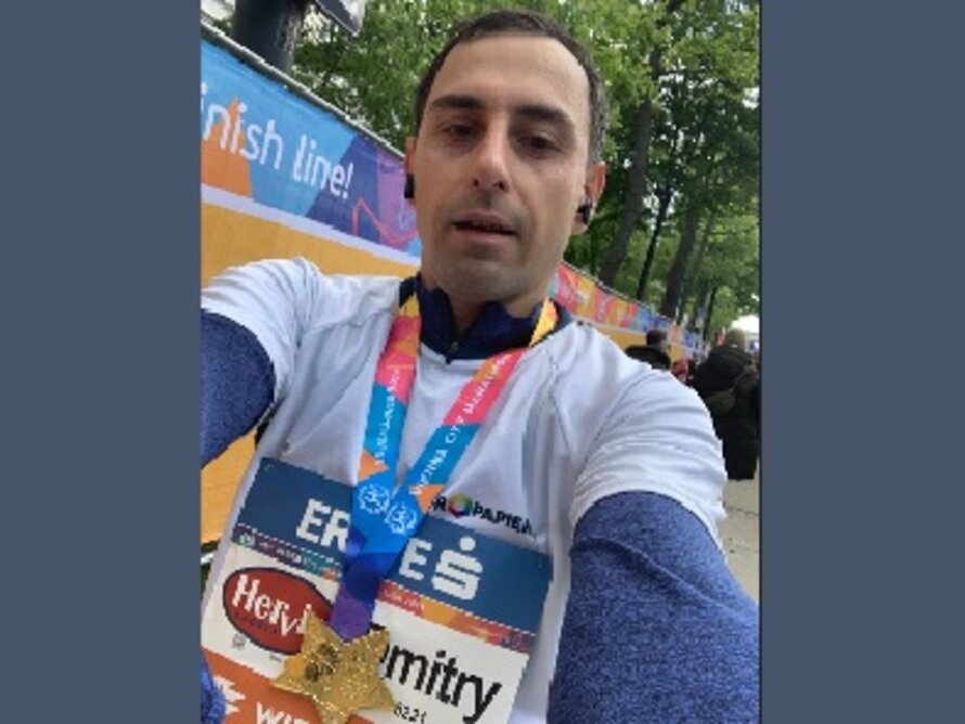 Selfie von Mann im Laufgewand mit Medaille